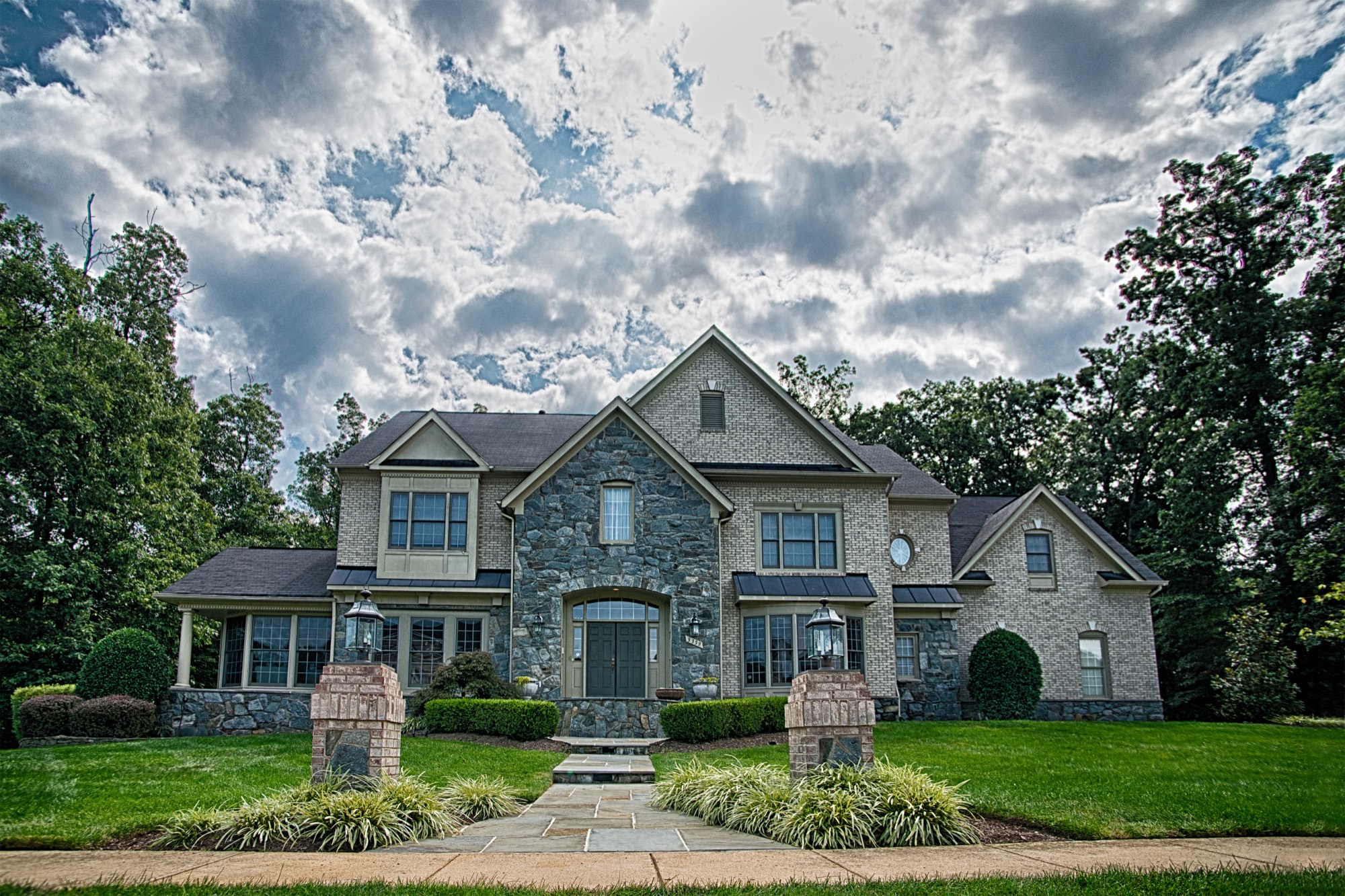 Stone-veneer home with flagstone front walkway and brick pillars in Northern Virginia