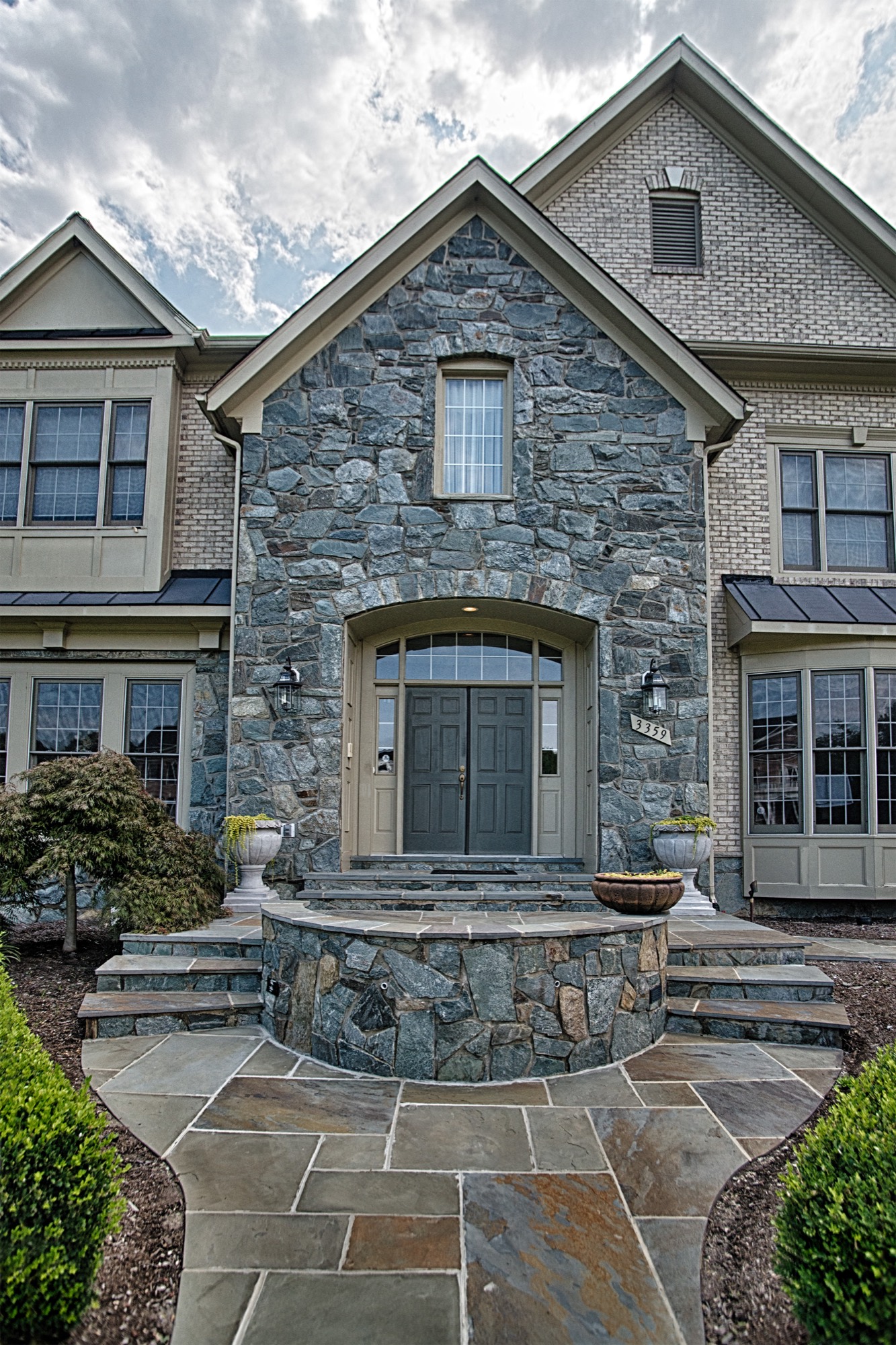 Curved natural stone wall with steps at a home entrance in Northern Virginia