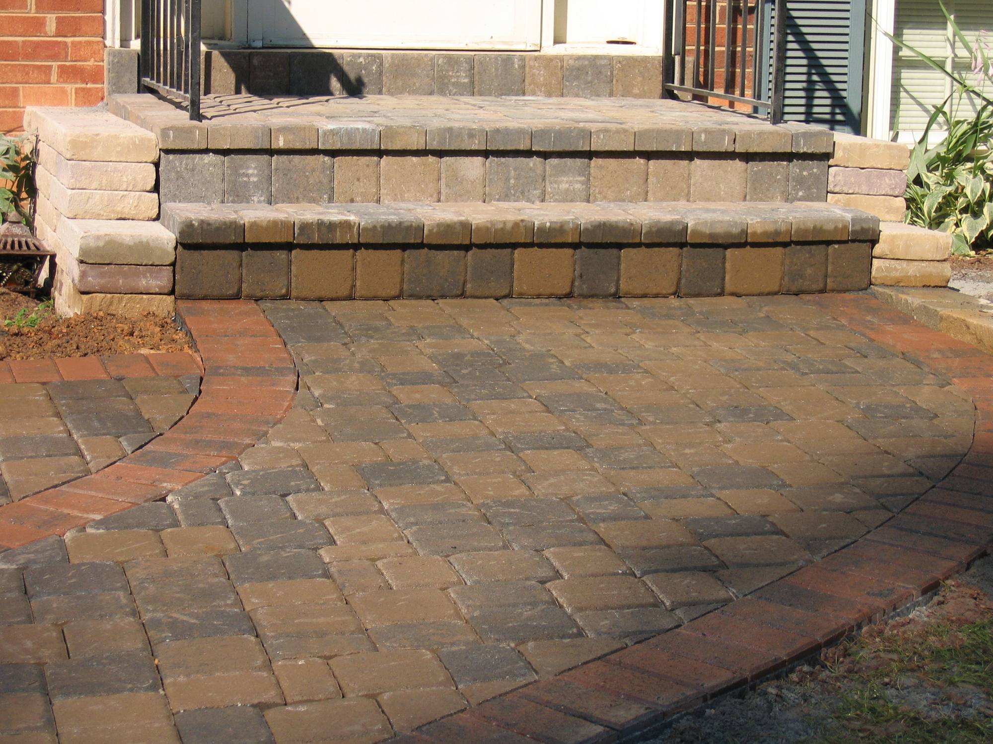 Brick-tone paver patio with steps and segmental sitting wall in Northern Virginia