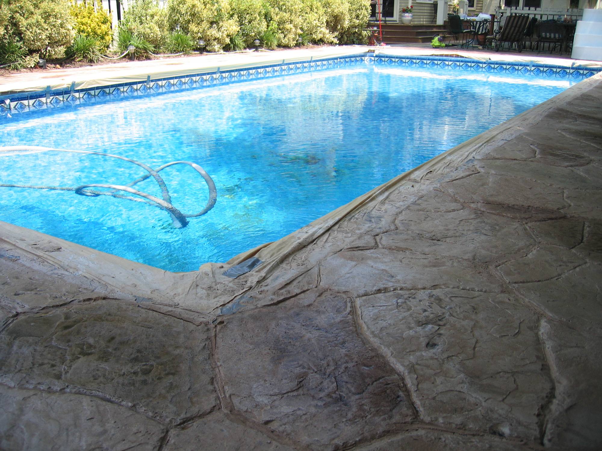 In-ground pool with stamped stone deck and coping in Northern Virginia