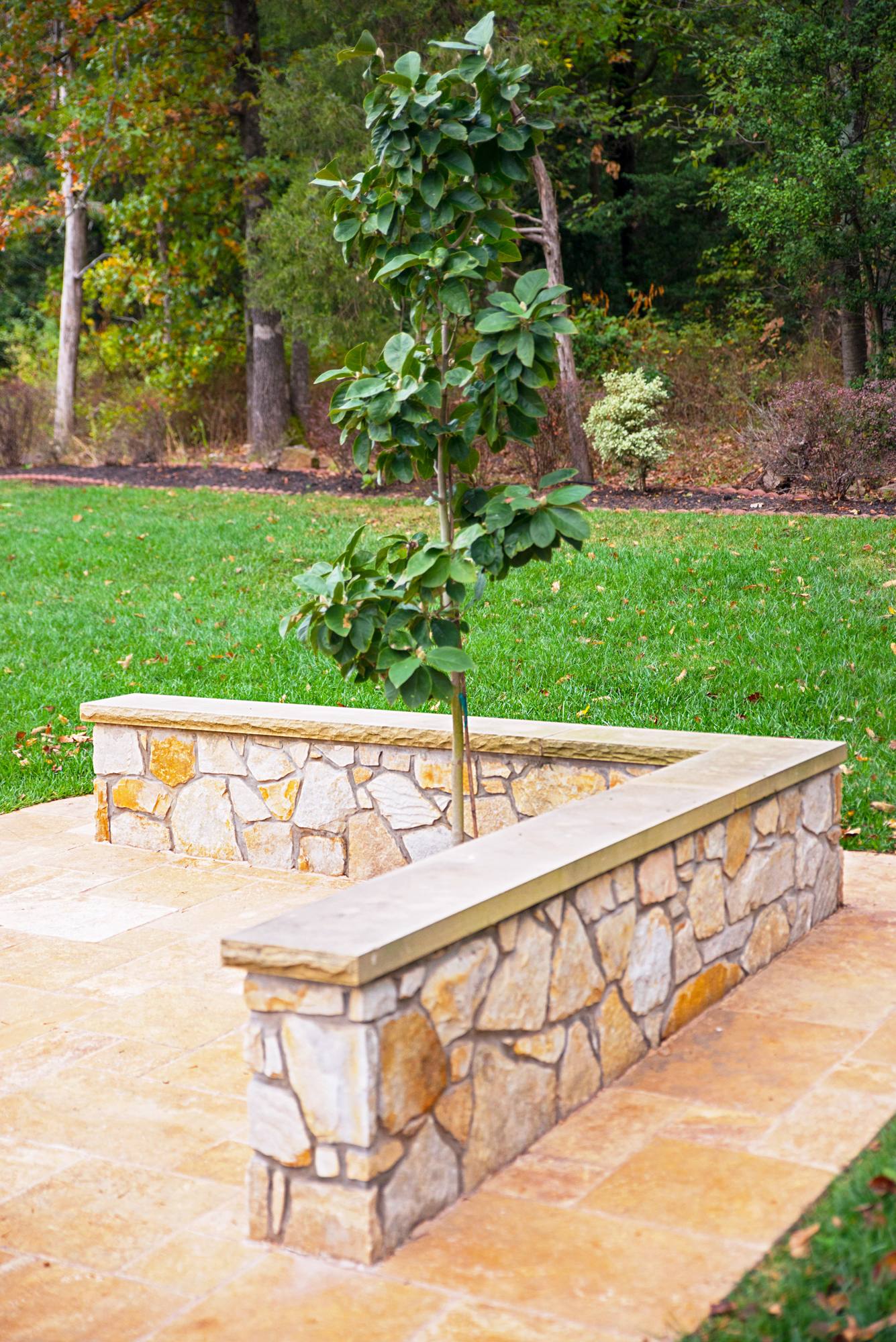 Stone veneer planter and sitting wall with flagstone cap in Northern Virginia